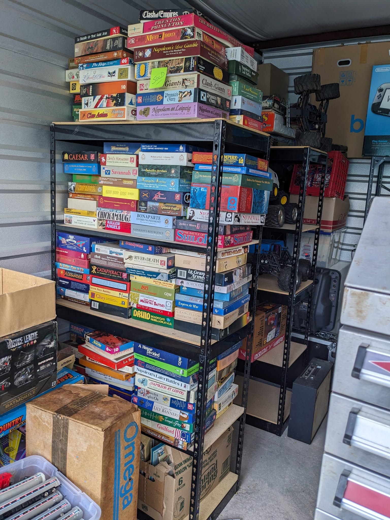 Shelving filled with a substantial collection of historical board and strategy games