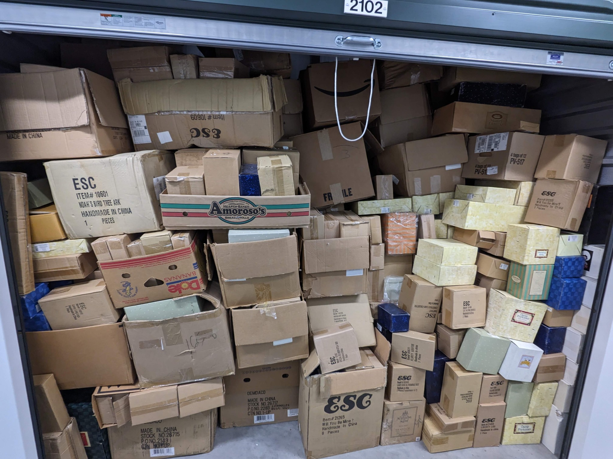 A large storage unit filled with boxed inventory and accumulated contents