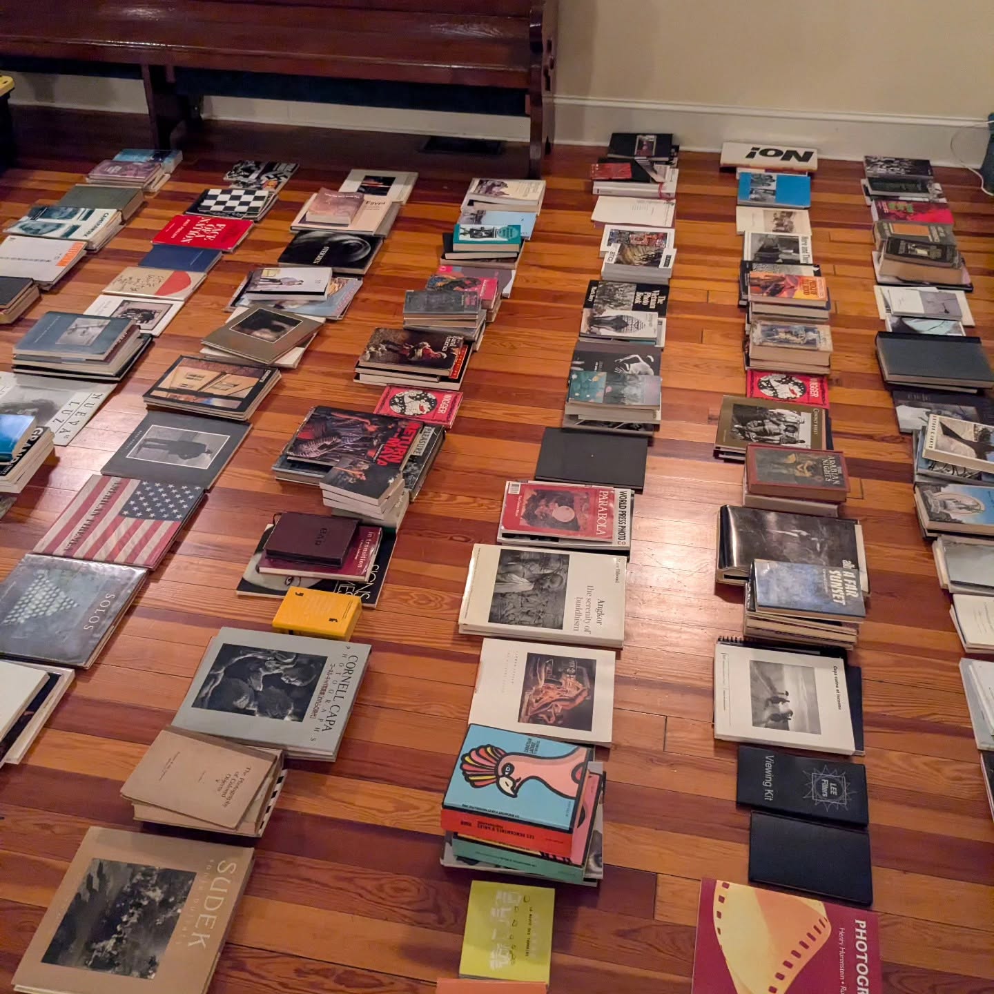 A specialist photography and art-book library arranged across a floor